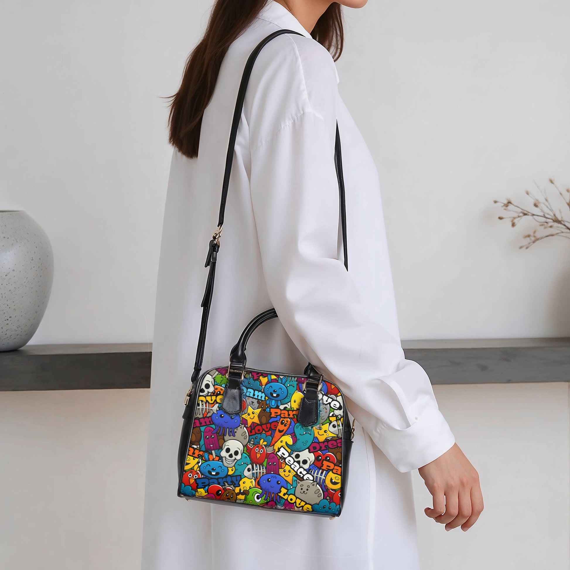 Person holding a colorful patterned handbag indoors