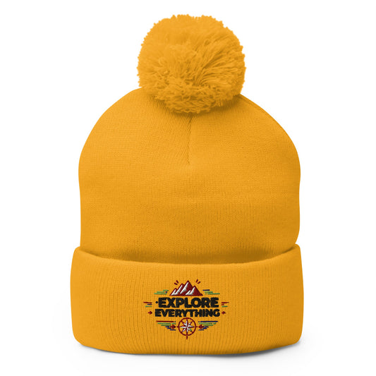 cozy embroidered pom-pom beanie! Featuring a bold "Explore Everything" design