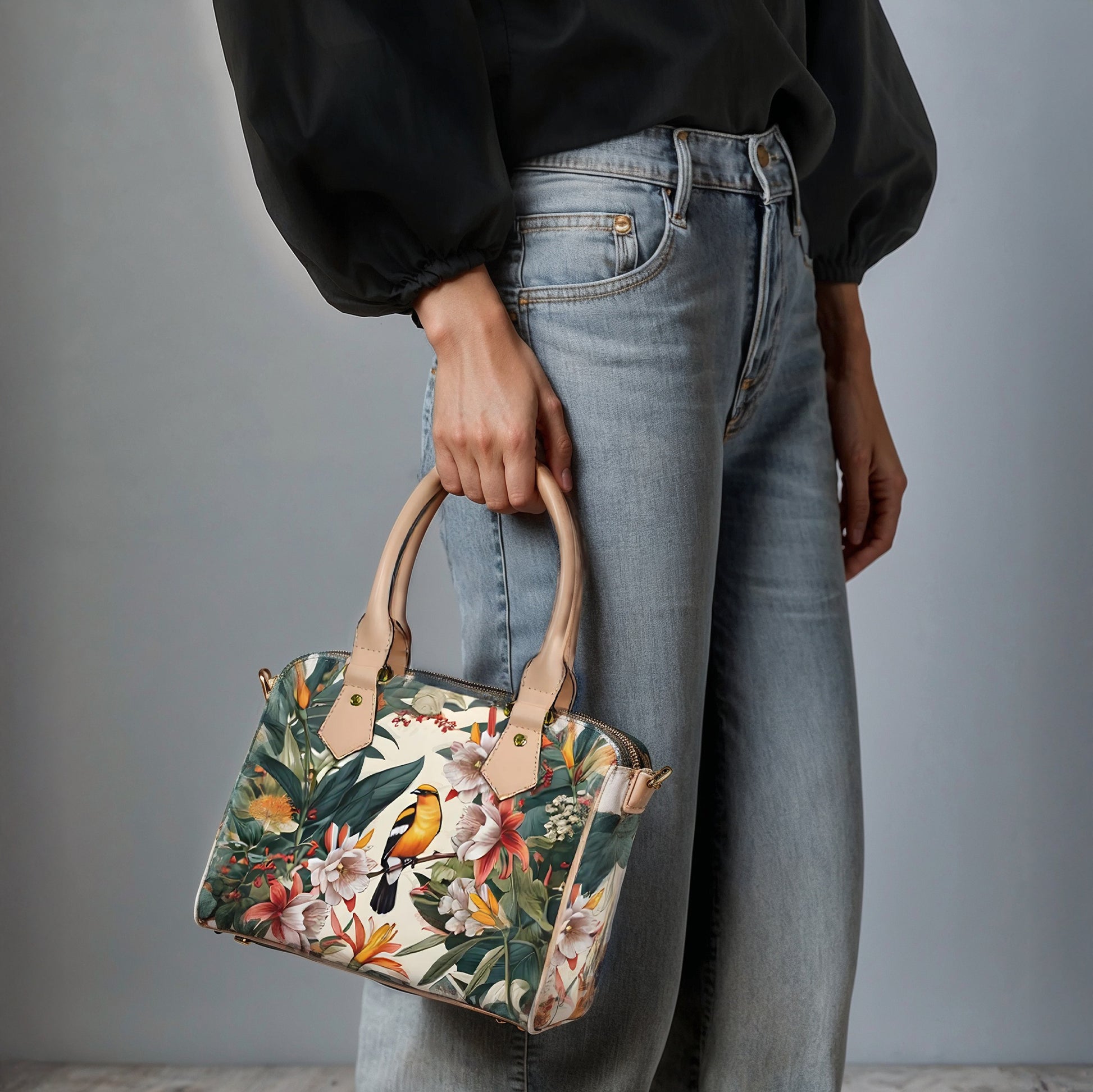 Person holding a floral handbag with a plain background